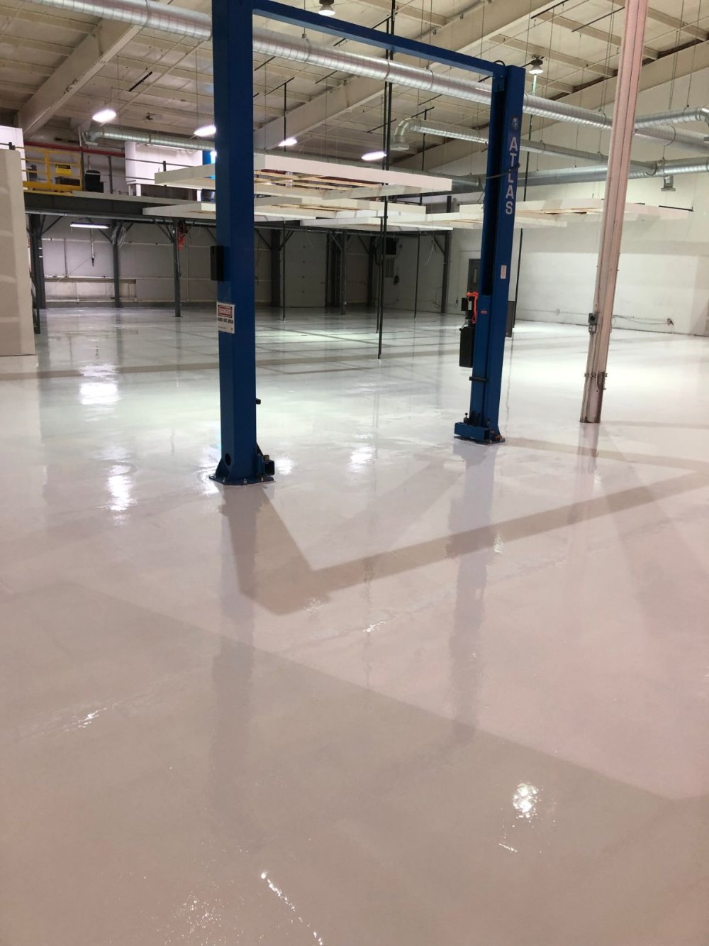 Brightly Lit Commercial Space with Newly Painted Walls and Floors
