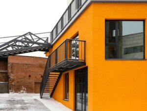 Commercial painters freshly painted building exterior in bright orange color